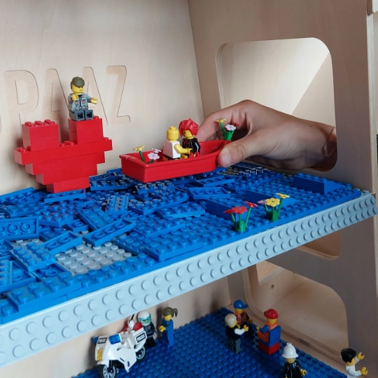 A swimming pool created by a 11 year old boy in a dollhouse.